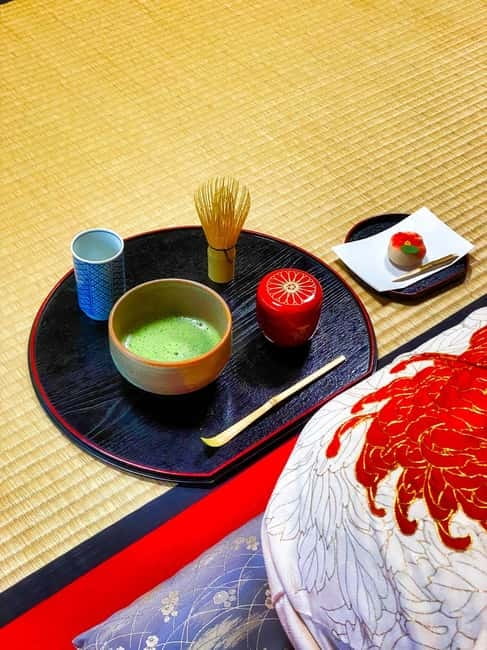 Whisked matcha and a seasonal sweet on a lacquer tray